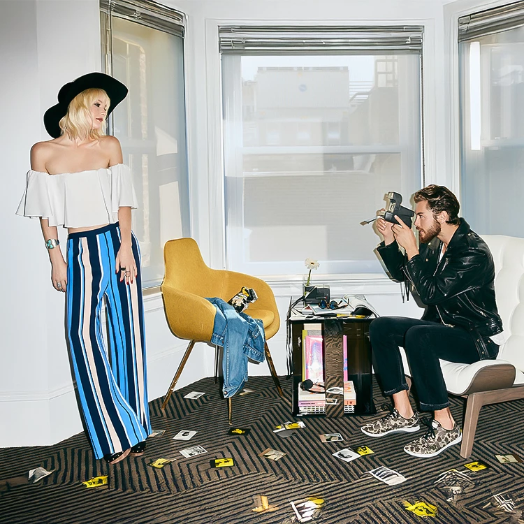 a man taking a picture of a woman in a room