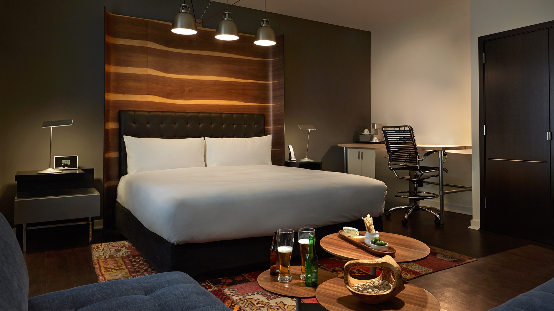 a room with a bed and a table with drinks