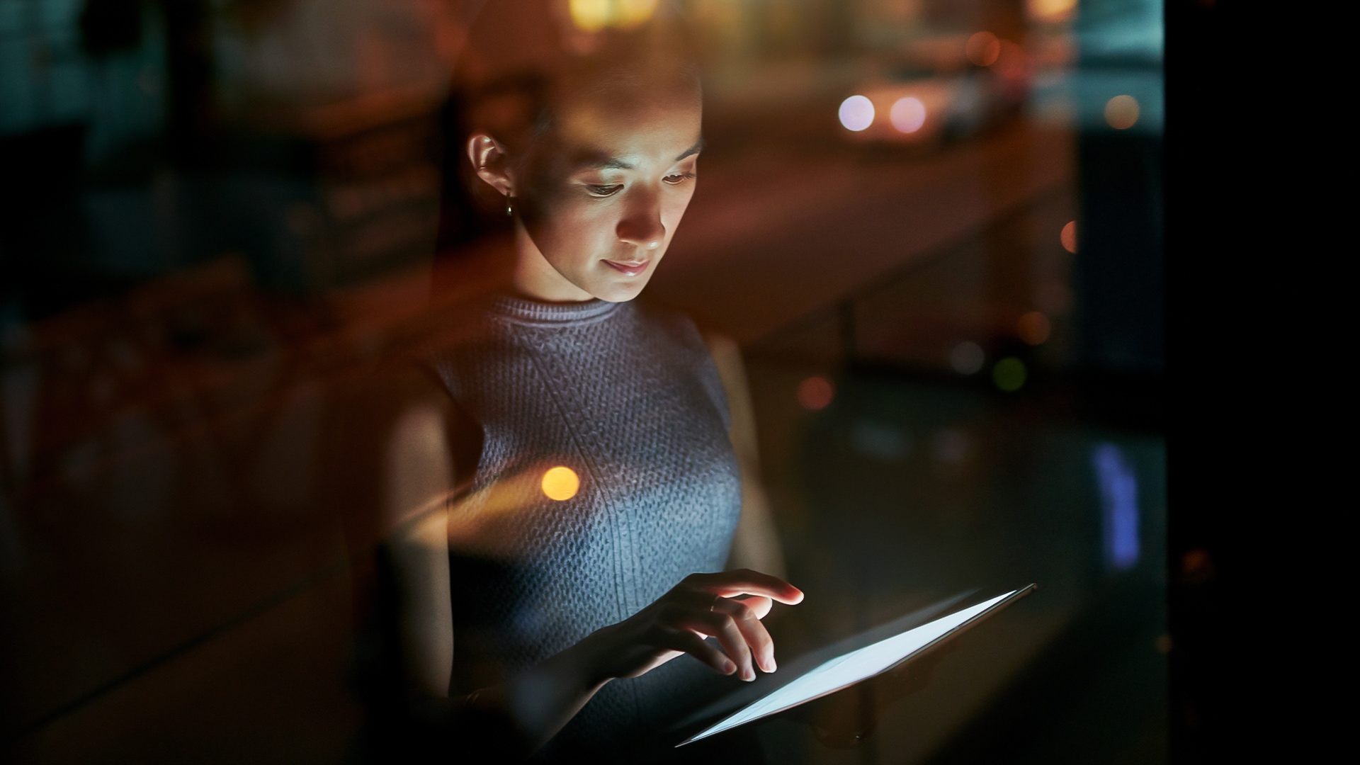 a woman looking at a tablet