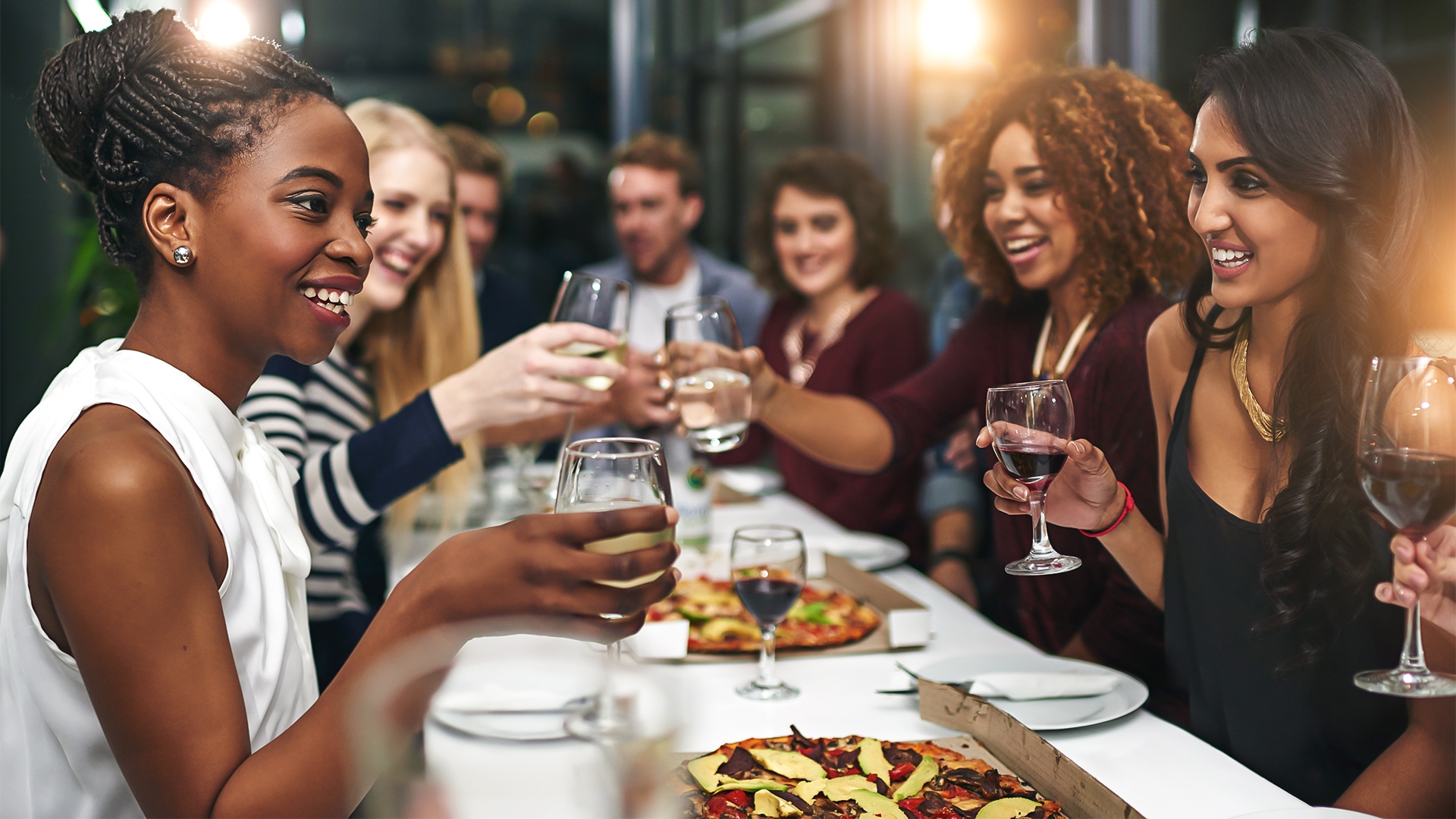 a group of people sitting at a table with wine glasses