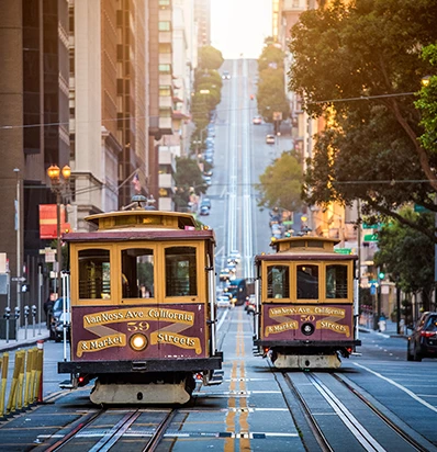 a two trolley cars on a street