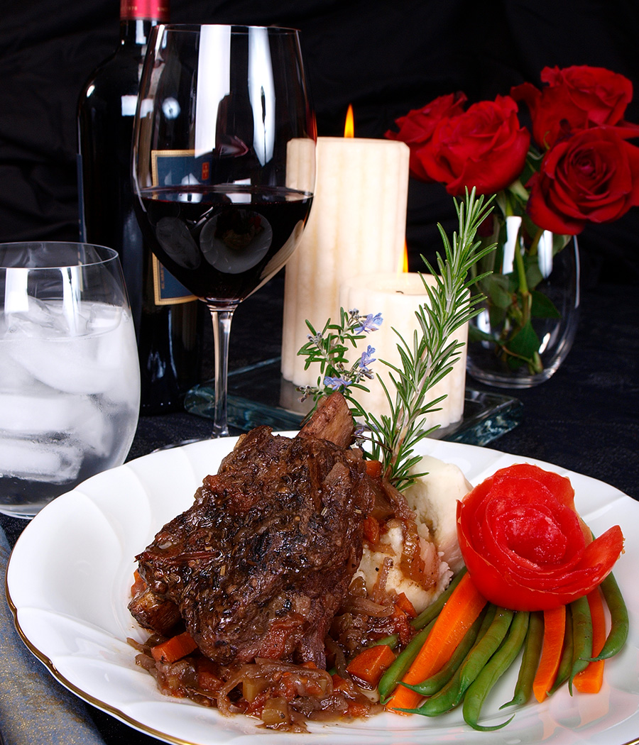 a plate of food and wine glasses