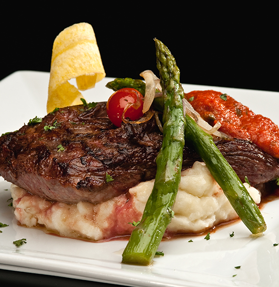 a plate of food on a black background