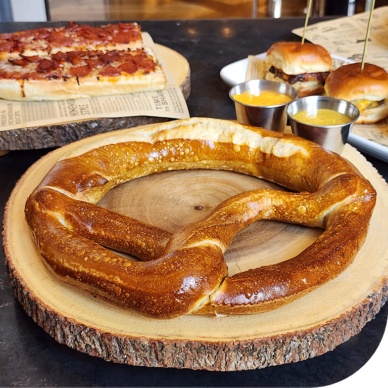 a pretzel on a wood platter