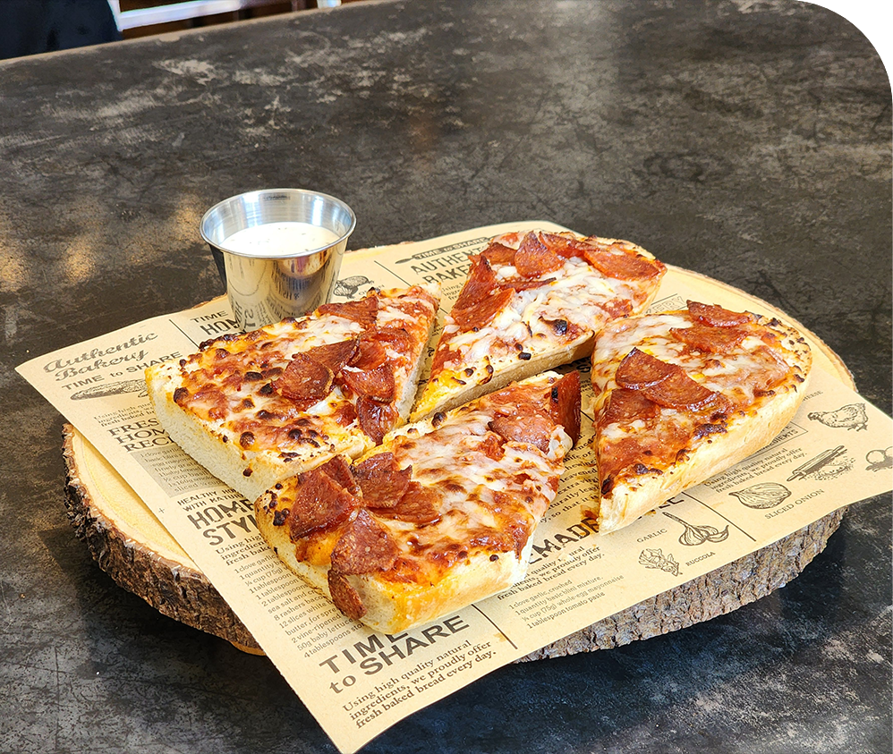 a pizza on a piece of wood