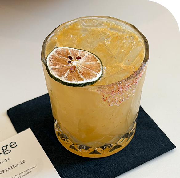 a glass with a drink and a slice of lime