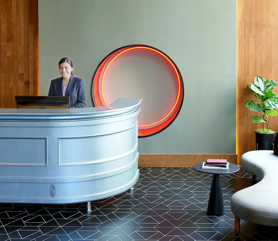 a woman standing at a reception desk