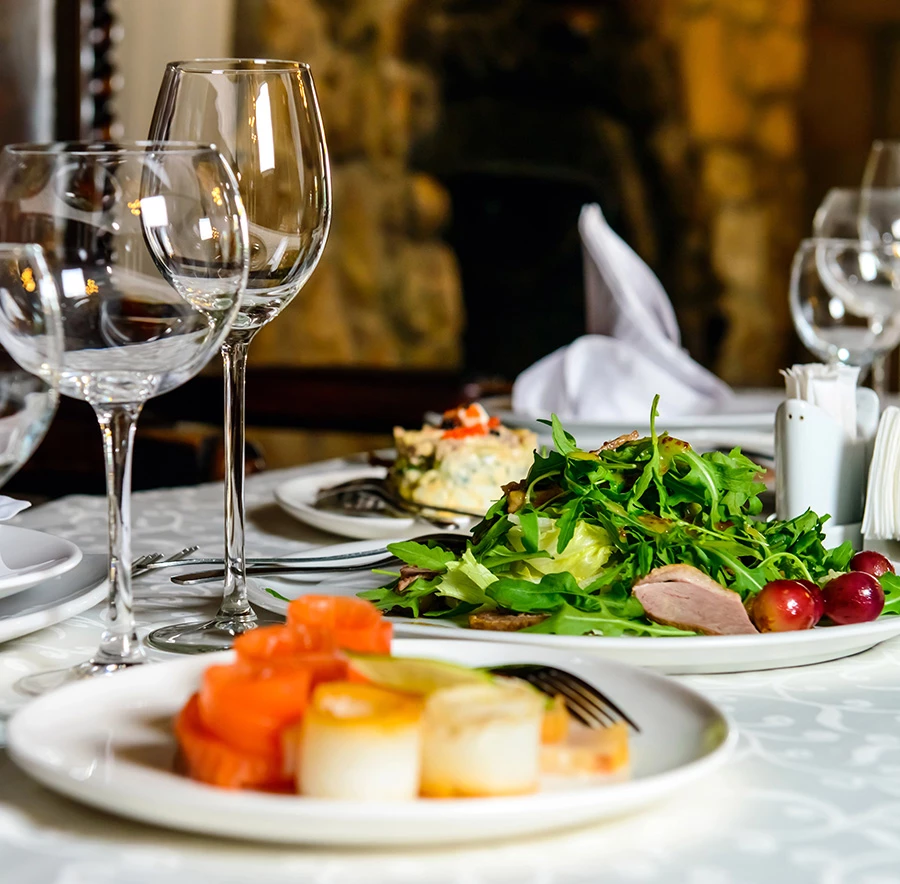 a table with plates of food and glasses