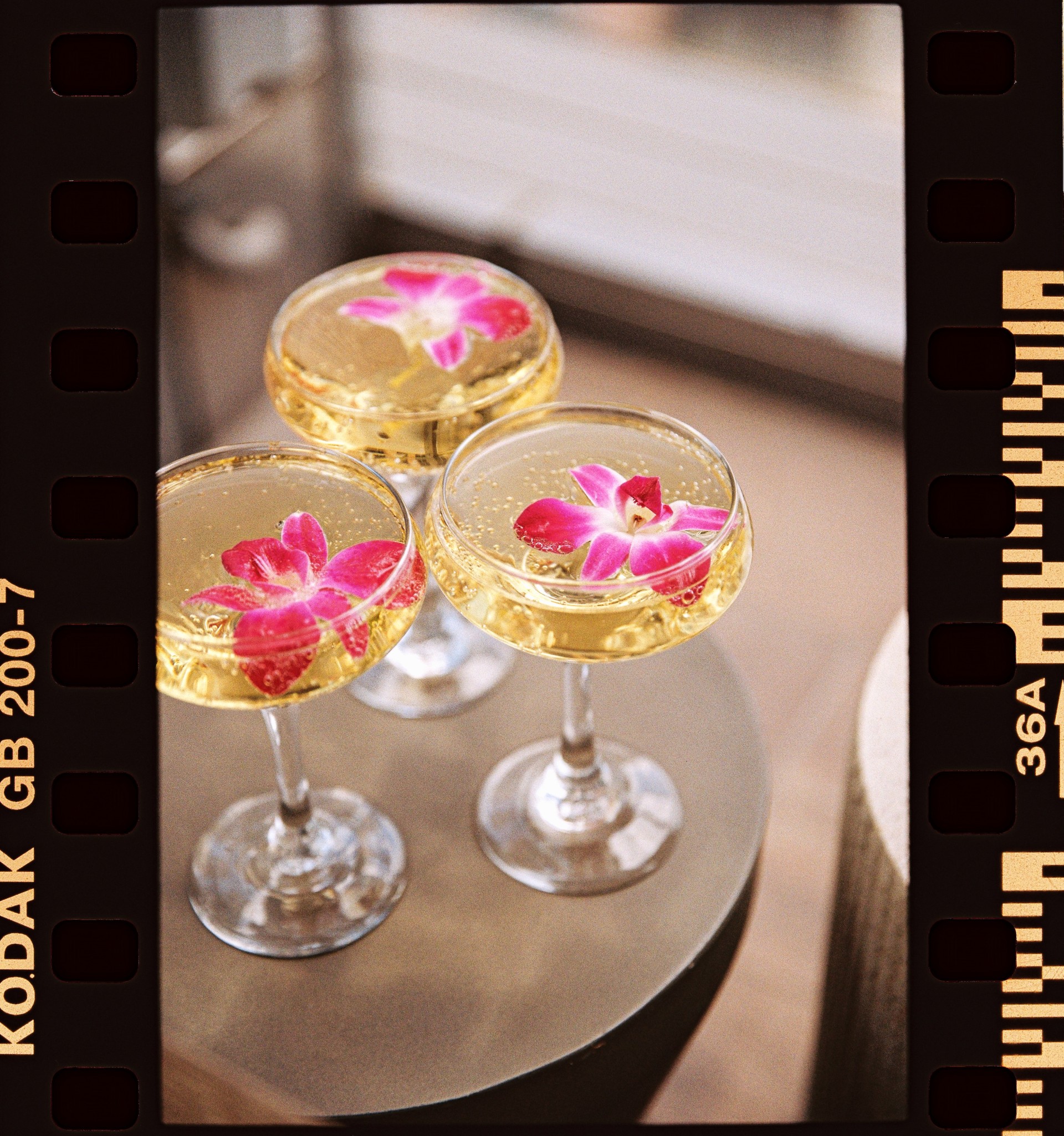a group of glasses with liquid and flowers on them
