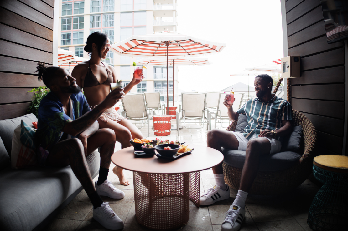 a group of people sitting in a private Keeper's Cabana