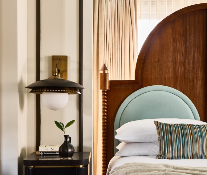 a lamp next to a bed