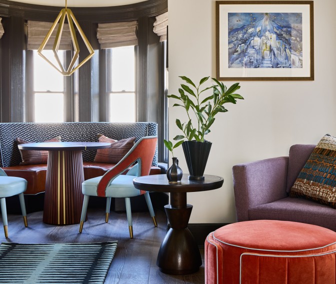 a room with a round table and chairs