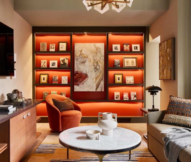 a living room with a coffee table and art on the wall