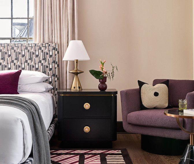 a bedroom with a bed and a purple chair