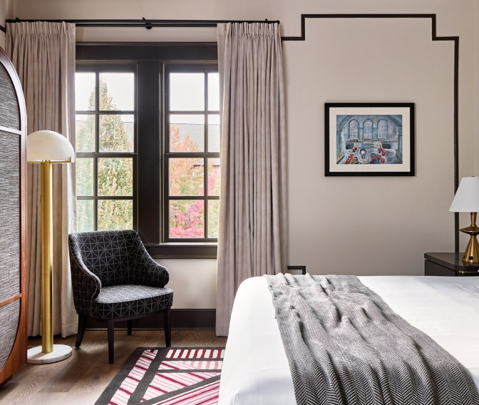 a bedroom with a bed and a chair