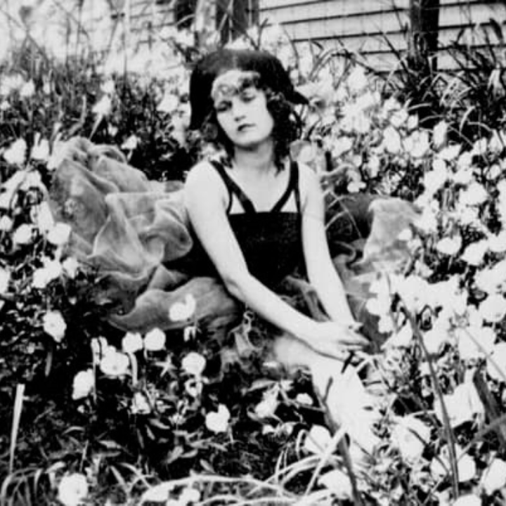 a woman sitting in a garden