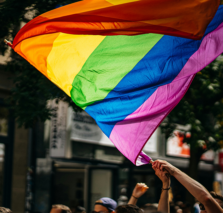 a group of people holding a rainbow flag