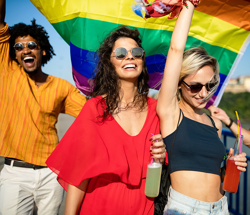 a group of people holding drinks and smiling