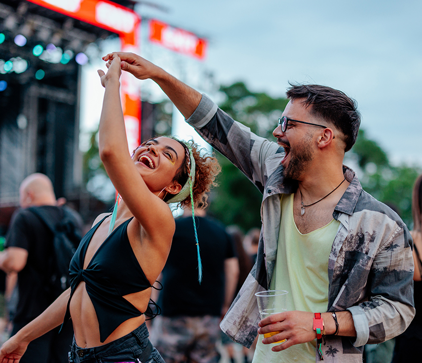 a man and woman dancing at a concert