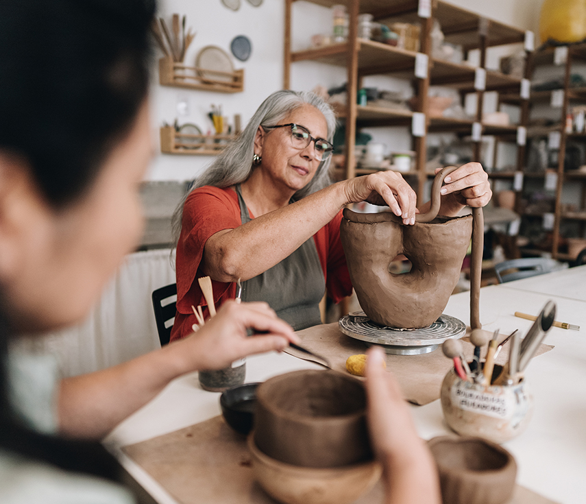 a woman painting a vase