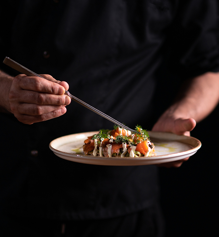 a person holding a plate of food