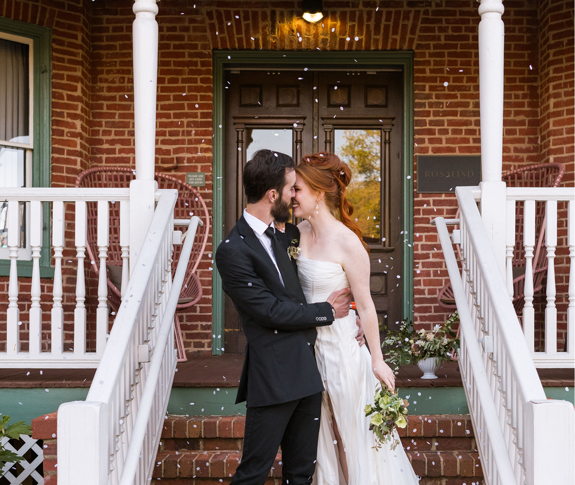 a man and woman kissing on stairs