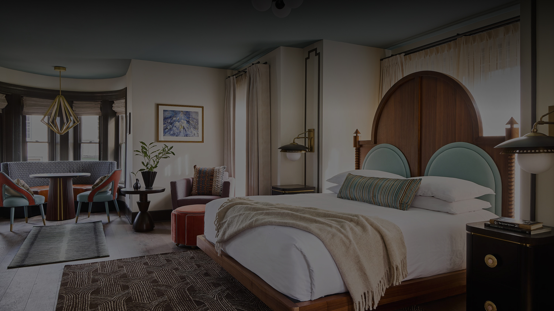 a room with a bed and chairs