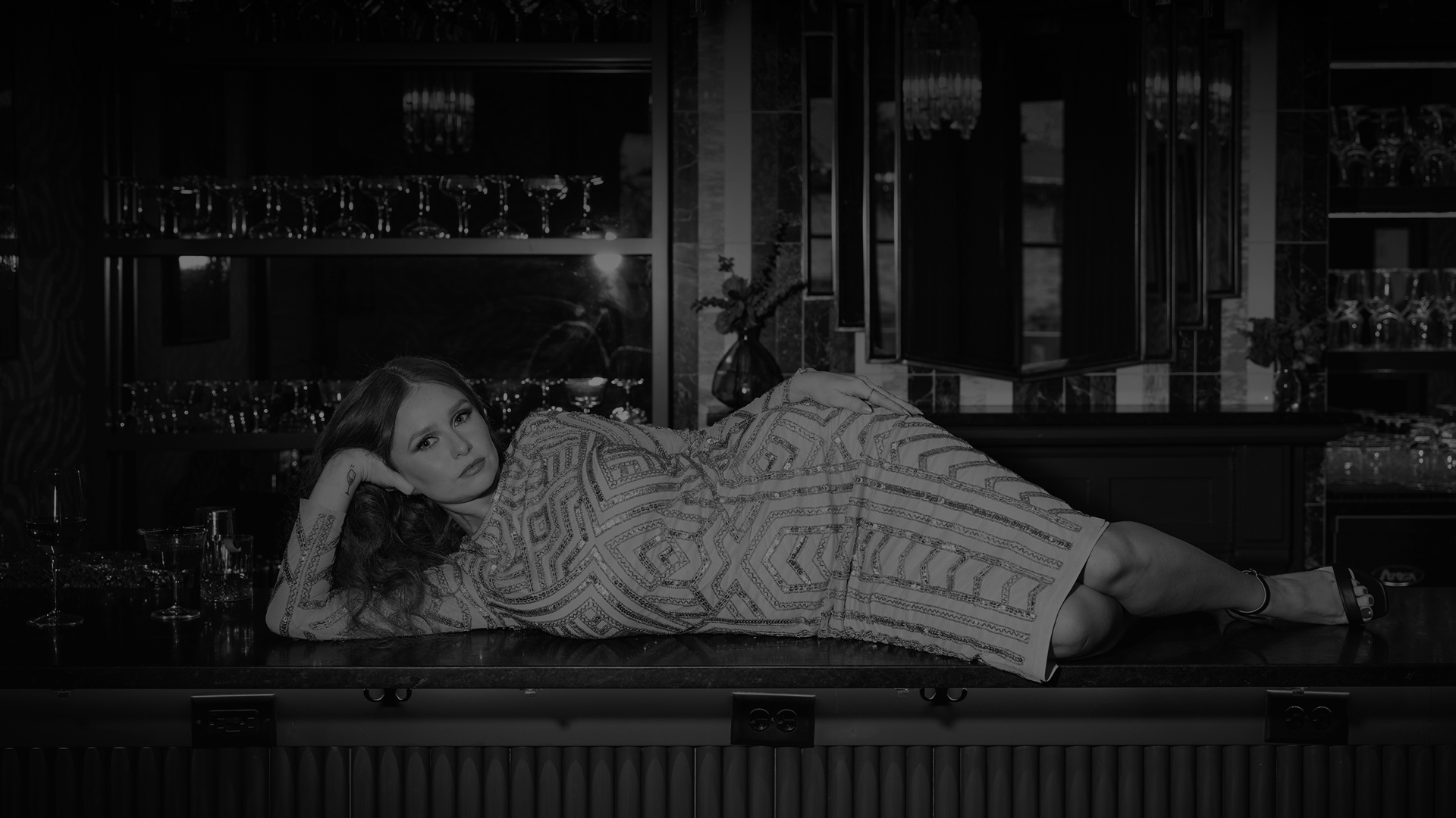 a woman lying on a bar