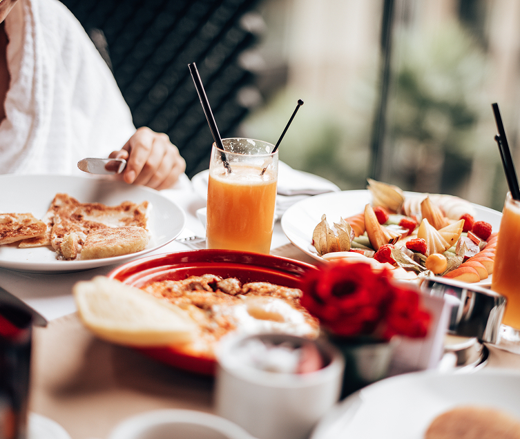 a table with plates of food and drinks