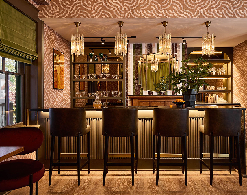 a bar with chairs and a mirror