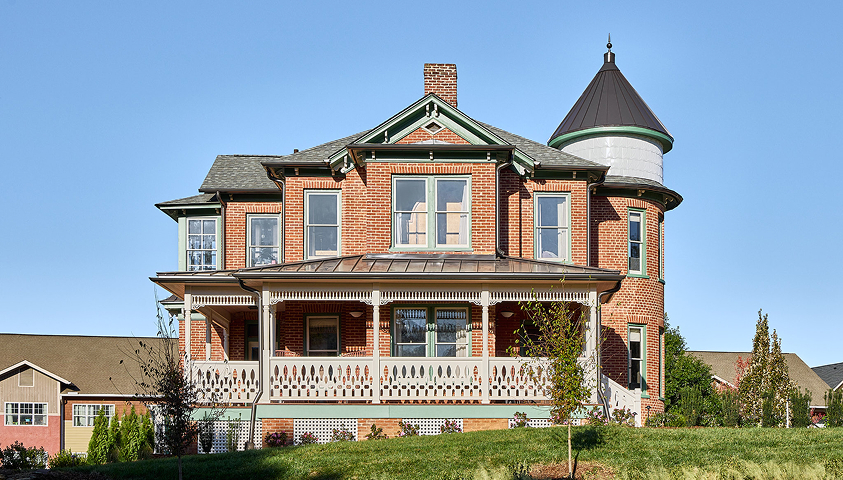 a brick house with a white railing
