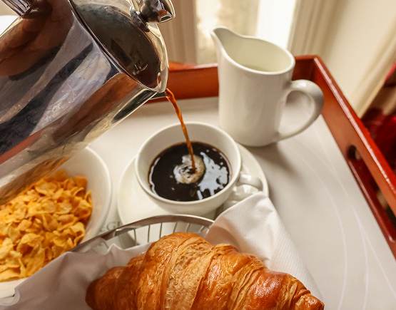 a coffee being poured into a croissant