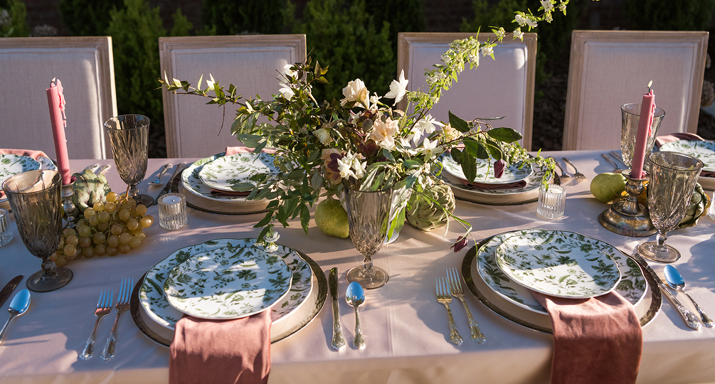a table set with plates and silverware