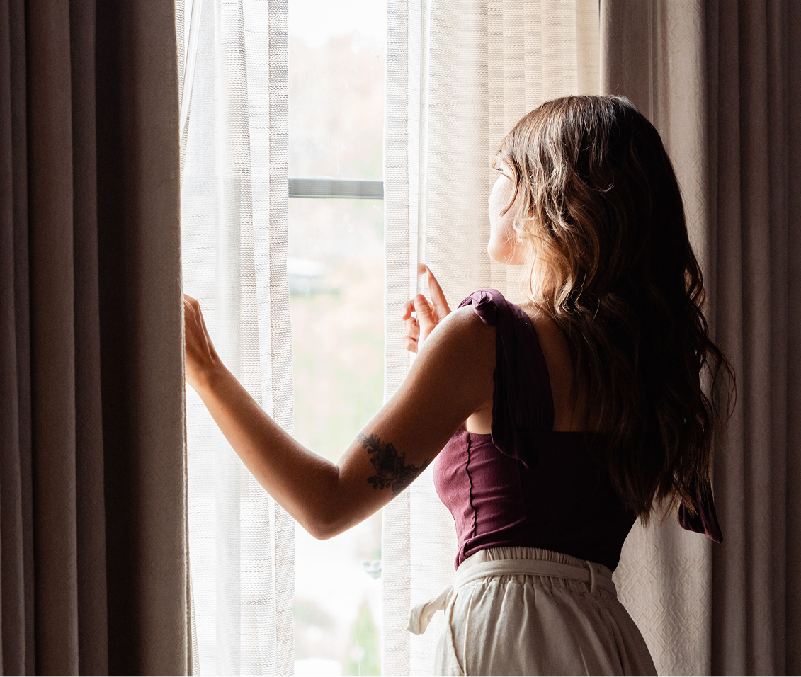 a woman looking out a window