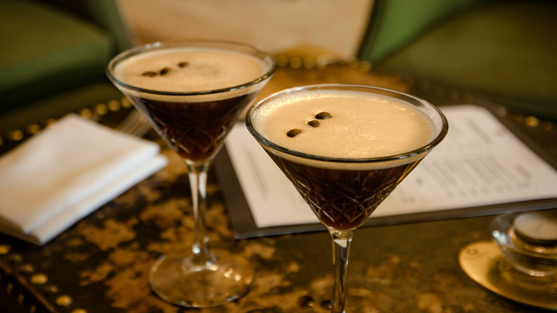 two glasses of liquid with brown liquid in it