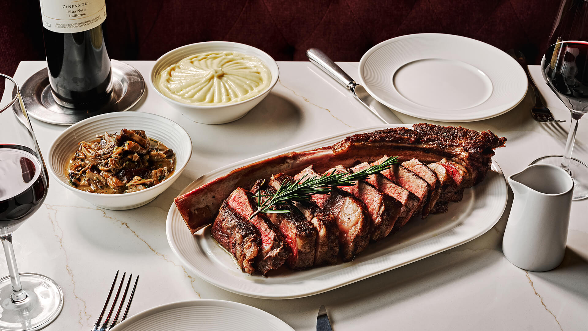 a plate of meat and a bowl of food