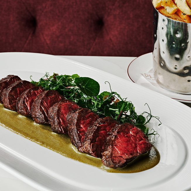 a plate of meat and fries